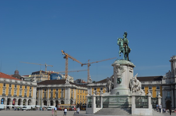 Past and future: historical buildings and cranes. 